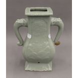 A Chinese twin handled celadon vase. 26.5 cm high.