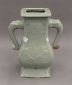 A Chinese twin handled celadon vase. 26.5 cm high.