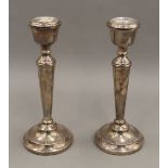 A pair of silver candlesticks. 20.5 cm high. 17.3 troy ounces loaded.