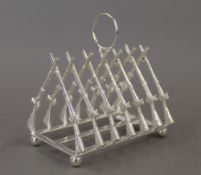 A silver plated rifle toast rack. 11 cm long.