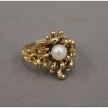 An 18 ct gold pearl set Contemporary ring. Ring size N/O. 7.8 grammes total weight.