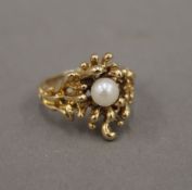 An 18 ct gold pearl set Contemporary ring. Ring size N/O. 7.8 grammes total weight.