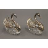 A pair of 925 silver mounted swan form salts and spoons. Each 6.5 cm high.