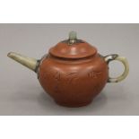 A Chinese Yixing teapot with jade mounts. 10 cm high.