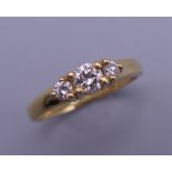 A vintage 18 ct gold three stone diamond ring. Centre stone approximately 0.20 carats.