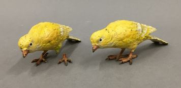 Two Austrian cold painted bronze models of canaries, each stamped 'Austria'. Each 12 cm long.
