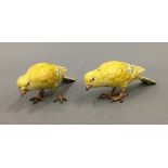 Two Austrian cold painted bronze models of canaries, each stamped 'Austria'. Each 12 cm long.