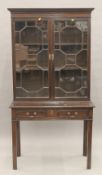 An Edwardian mahogany glazed bookcase on stand. 170 cm high x 91 cm wide.