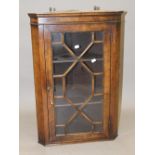 A modern walnut hanging corner cabinet. 79 cm high.