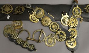 A quantity of horse brasses and straps.