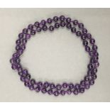 A string of amethyst beads. 72 cm long.