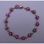 A 9 ct gold heart shaped rhodolite garnet stone bracelet. 18.5 cm long. 8.2 grammes total weight.