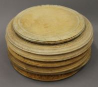 A collection of bread boards and a bread knife. The largest 30 cm diameter.