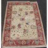 A white ground rug. 138 x 202 cm.