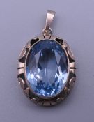 A 14 ct gold blue stone, possibly aquamarine pendant. 3 cm high. 9.4 grammes total weight.