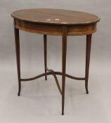 An Edwardian mahogany oval centre table. 73 cm long.