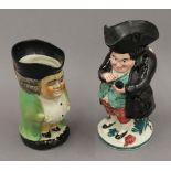 A 19th century Snuff Taker toby jug and another. The former 20 cm high.