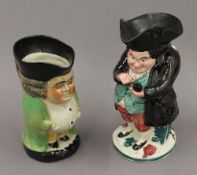 A 19th century Snuff Taker toby jug and another. The former 20 cm high.