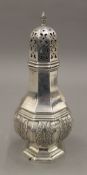 A silver sugar caster with cast acanthus decoration. 19 cm high. 6.7 troy ounces.