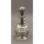 A silver sugar caster with cast acanthus decoration. 19 cm high. 6.7 troy ounces.