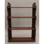 A Victorian walnut hanging shelf. 61.5 cm wide.