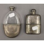 A silver mounted hip flask and a plated hip flask. The former 14.5 cm high.