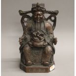 A Chinese bronze model of an Emperor holding a censer. 23 cm high.