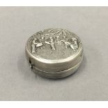 A Chinese unmarked silver tape measure. 4 cm diameter.