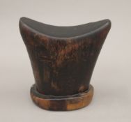 A wooden tribal headrest. 15 cm high.