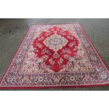 A large modern red ground rug. 237 x 317 cm.