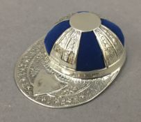 A sterling silver jockey cap pin cushion. 4 cm wide.