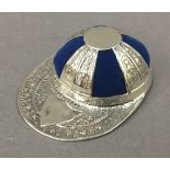 A sterling silver jockey cap pin cushion. 4 cm wide.