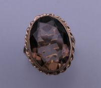 A 9 ct gold topaz/smoky quartz ring. Ring size L/M. 6.2 grammes total weight.