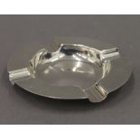 A silver ashtray. 10 cm diameter.