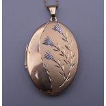 A 9 ct gold locket on a 9 ct gold chain. 3.5 cm high. 8 grammes total weight.