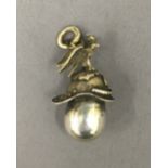 A pendant formed as a Russian helmet and egg. 3.5 cm high.