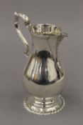 A silver cream jug. 13 cm high. 7 troy ounces.