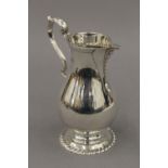 A silver cream jug. 13 cm high. 7 troy ounces.