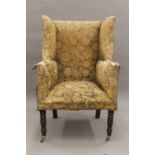 A 19th century upholstered wing back armchair. 73 cm wide.