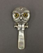 A silver rattle formed as an owl. 7 cm high.
