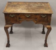 An 18th century feather banded walnut lowboy. 75.5 cm wide, 70 cm high, 45.