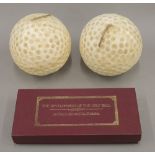 Two large golf ball candles and a boxed Development of the Golf Ball Set.