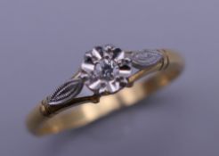 An 18 ct gold diamond flower head ring. Ring size P. 2.7 grammes total weight.