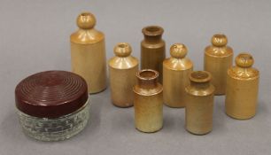 A quantity of miniature Doulton Lambeth bottles. The largest 7.5 cm high.