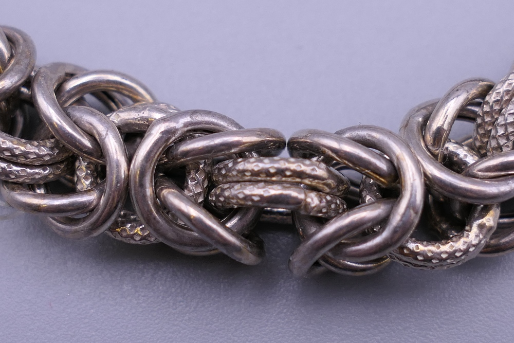 A silver ladies entwined link bracelet. 19 cm long. 31.2 grammes. - Image 2 of 4