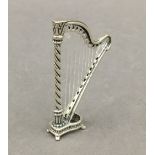 A small silver model of a harp. 5.5 cm high.
