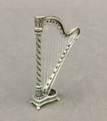 A small silver model of a harp. 5.5 cm high.