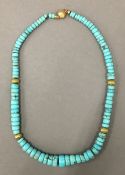 A turquoise necklace with 18 ct gold mounts. 51 cm long.