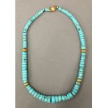 A turquoise necklace with 18 ct gold mounts. 51 cm long.