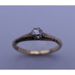 An 18 ct gold diamond solitaire ring. Ring size O. 2.4 grammes total weight.
